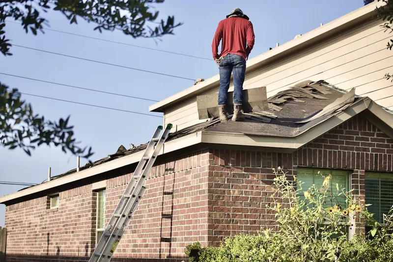 Professional roofer working on a residential roof in McLendon-Chisholm
